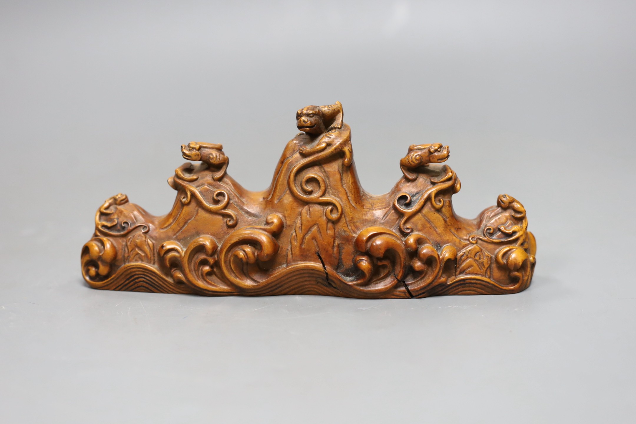 A Chinese carved wood brush rest, 18cms wide